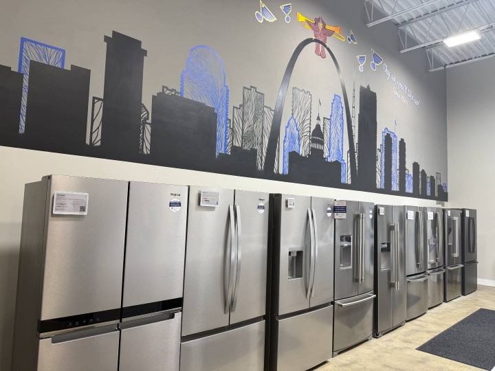 Slyman Bros St. Louis City store refrigerator display with St. Louis skyline painting.